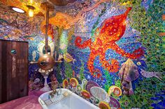 a bathroom with colorful tiles on the walls and floor, along with a bathtub