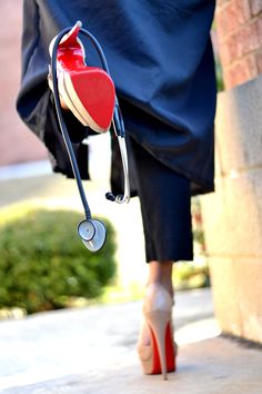 a woman's foot with a stethoscope attached to her ankle and wearing high heels