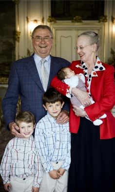 an older man, woman and two children posing for a photo