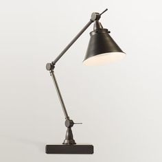 a black desk lamp with a white light on the top and one arm extended up