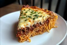 a slice of lasagna on a white plate with parsley sprinkled on top