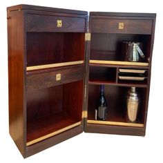 an open wooden cabinet with two shelves and bottles