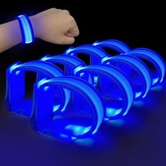 a hand is reaching for some glowing blue objects