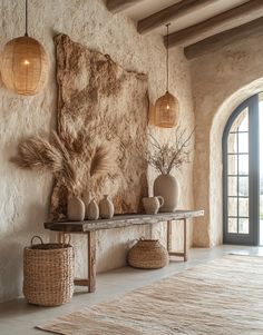 a living room with stone walls and flooring, two vases on a table