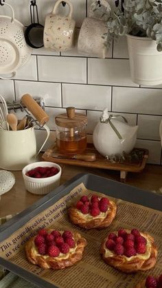 raspberries are on top of bread in the kitchen