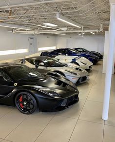 a bunch of cars are parked in a garage with no one around them on the floor