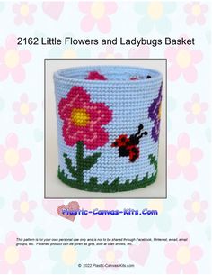 a crocheted basket with flowers and ladybugs painted on the front side