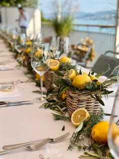 the table is set with lemons and greenery for an elegant dinner or party