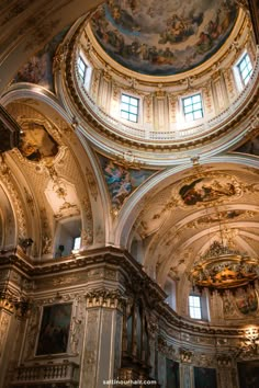 the interior of an ornate church with painted ceilings