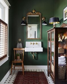 a bathroom with green walls and white flooring