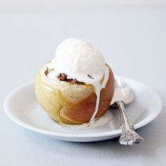 an apple covered in ice cream on a white plate