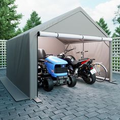 two motorcycles are parked in front of a tent with a motorbike attached to it