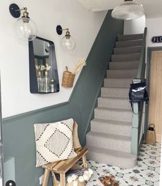 the stairs are painted green and white with decorative rugs on each side, along with baskets