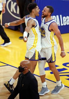 two basketball players congratulate each other on the court