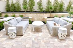 an outdoor seating area with couches and tables