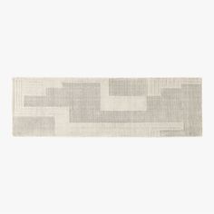 a white and grey rug with squares on it