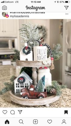 a tray with christmas decorations and candles on it in the middle of a kitchen counter