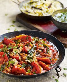 a pan filled with lots of food on top of a table