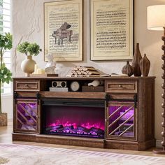 a living room with a fireplace and two framed pictures on the wall above it,