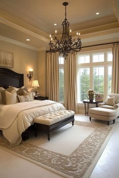 a large bedroom with a chandelier and two chairs