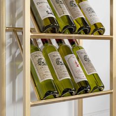 several bottles of wine sit on shelves in a room