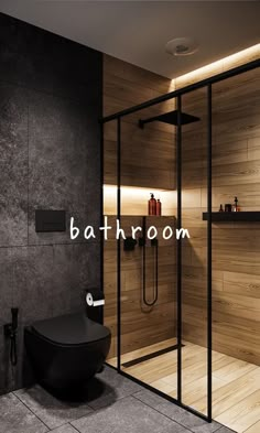 a bathroom with a black toilet and wooden walls, along with the words bathroom above it