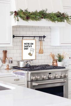 a stove top oven sitting inside of a kitchen next to a counter with utensils on it