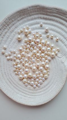 a white plate topped with lots of pearls