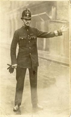 an old black and white photo of a man in uniform holding his arms out to the side