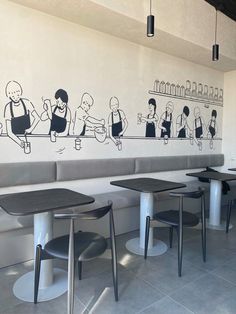 a restaurant with black and white drawings on the wall