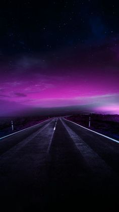 an empty road in the middle of nowhere under a purple sky with stars and clouds