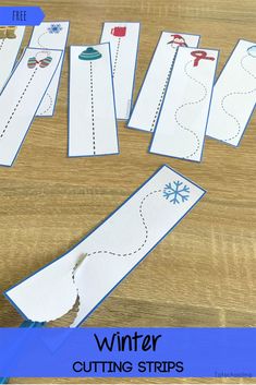 paper cut out to look like winter cutting strips on a table with scissors and glue