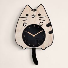 a wooden clock with a cat face on it's face and the hands are black