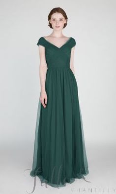 a woman in a long green dress