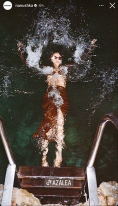 a woman is swimming in the water with her arms outstretched