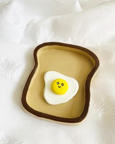 an egg in the shape of a toast with a smiley face