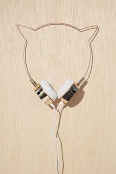 a pair of headphones attached to a wooden board with ears on it and wires running through the middle