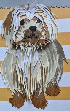 a paper cut out of a dog with long hair