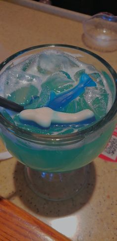 a blue and white drink in a glass bowl