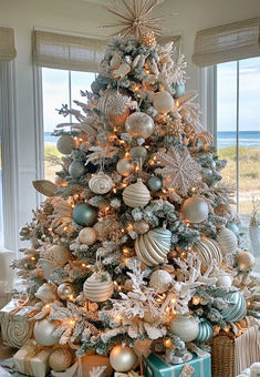 Coastal Christmas Tree Decor Ideas Coastal Flocked Christmas Tree, Blue Beach Christmas Decor, Island Christmas Tree, Coastal Themed Christmas Tree, Beach Christmas Trees Decorations, Costal Christmas Trees, Christmas Tree Ideas Light Blue, Beach House Christmas Tree, Coastal Christmas Tree Decorations