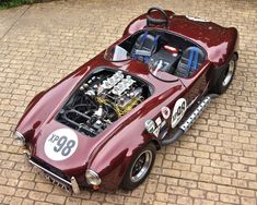 an overhead view of a red race car with the engine in it's compartment