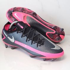 a pair of nike soccer cleats with pink and black accents on the soles