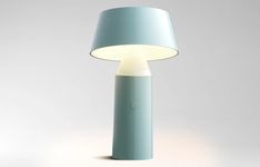 a blue lamp with a white light on it's side and a grey background