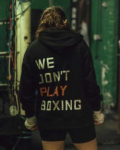 the back of a woman's hoodie that says we don't play boxing