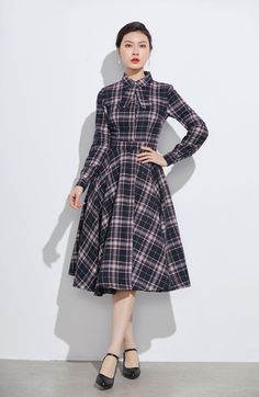 "Simple. With its pleated skirt and grayscale plaid pattern, this vintage wool dress epitomizes classic styling. She's all class and quality with no bells or whistles. Near-perfect custom made vintage inspired condition, designed with lapel collar, long sleeves and tie belt waist, it will be your favorite one of your wardrobe. Details: * 30% wool, 30% fiber, 40% polyester * fully satiny lining, more nice to the touch body * Invisible Front buttons, right zipper closed * Two seam pockets * long s Warm Winter Dresses, Vintage Midi Dresses, Dress Autumn, Long Wool Coat, Dress Long Sleeves, Wool Clothing, White Dresses For Women, Fashion Hub, Winter Dress