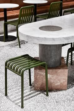 the table and chairs are all made out of concrete blocks with green slats on them