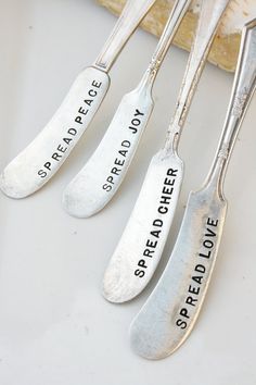 three spoons with words on them sitting next to each other