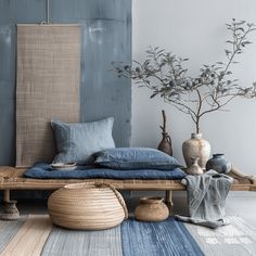 a bed sitting on top of a wooden floor next to a vase