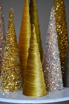 gold and silver glitter trees on a white shelf