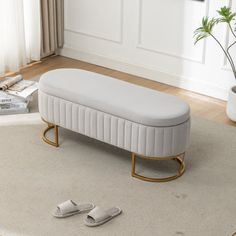 a white bench sitting on top of a rug